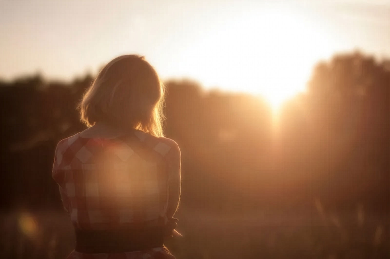 woman in field during sunrise