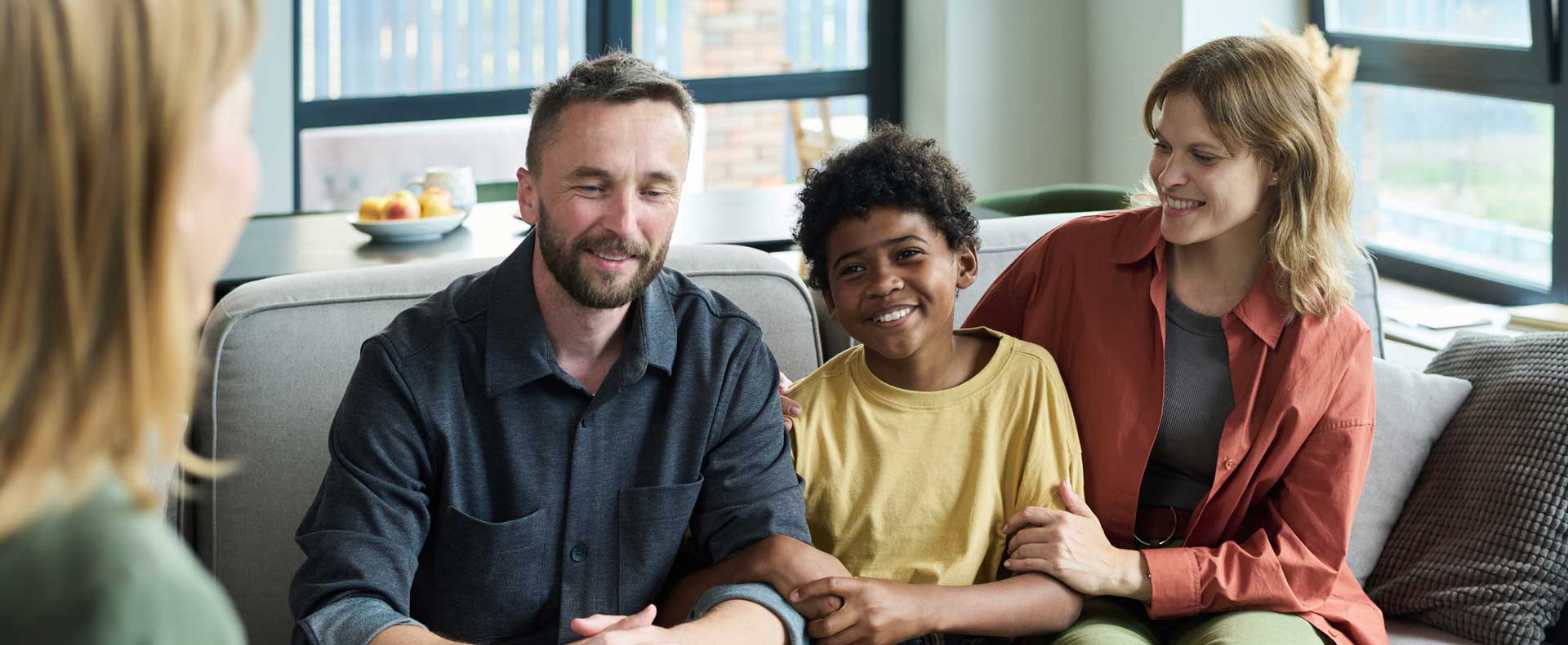 A family of three attending a therapy session